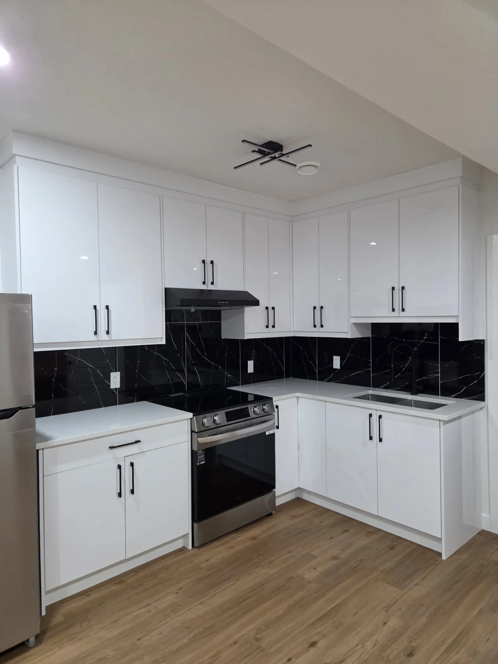 Modern kitchen with dark cabinetry and island, Calgary
